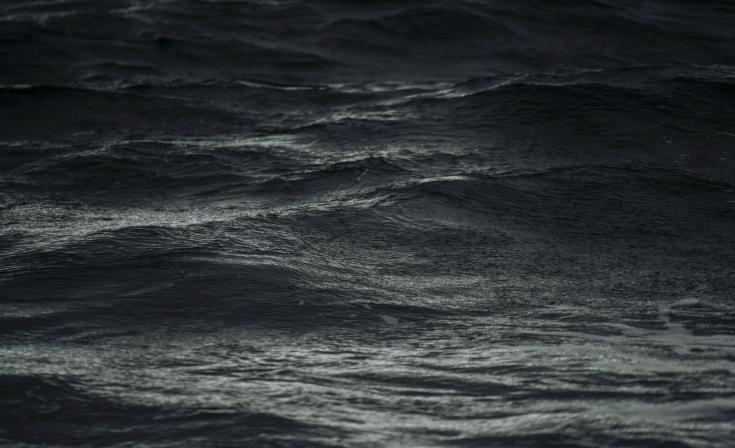 A rough, dark body of water